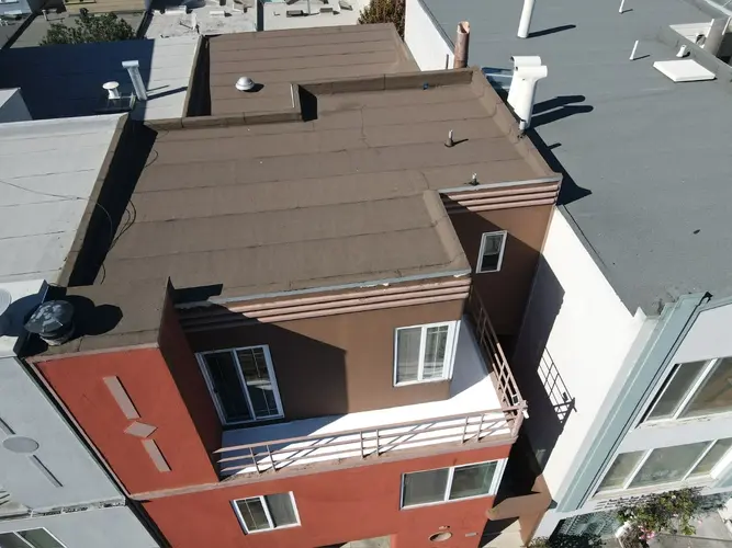 Torch down flat roofing system installed on a San Francisco home, showing clean seams and professional finish from an overhead perspective