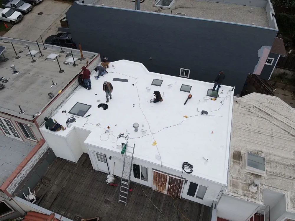San Francisco roofing contractors installing white TPO roof on residential flat roof
