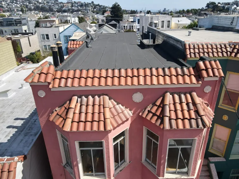 Tile roof replacement on a San Francisco home with flat roof and Spanish-style red clay tiles