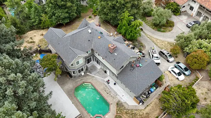 gray roof double story with swiming pool and cars