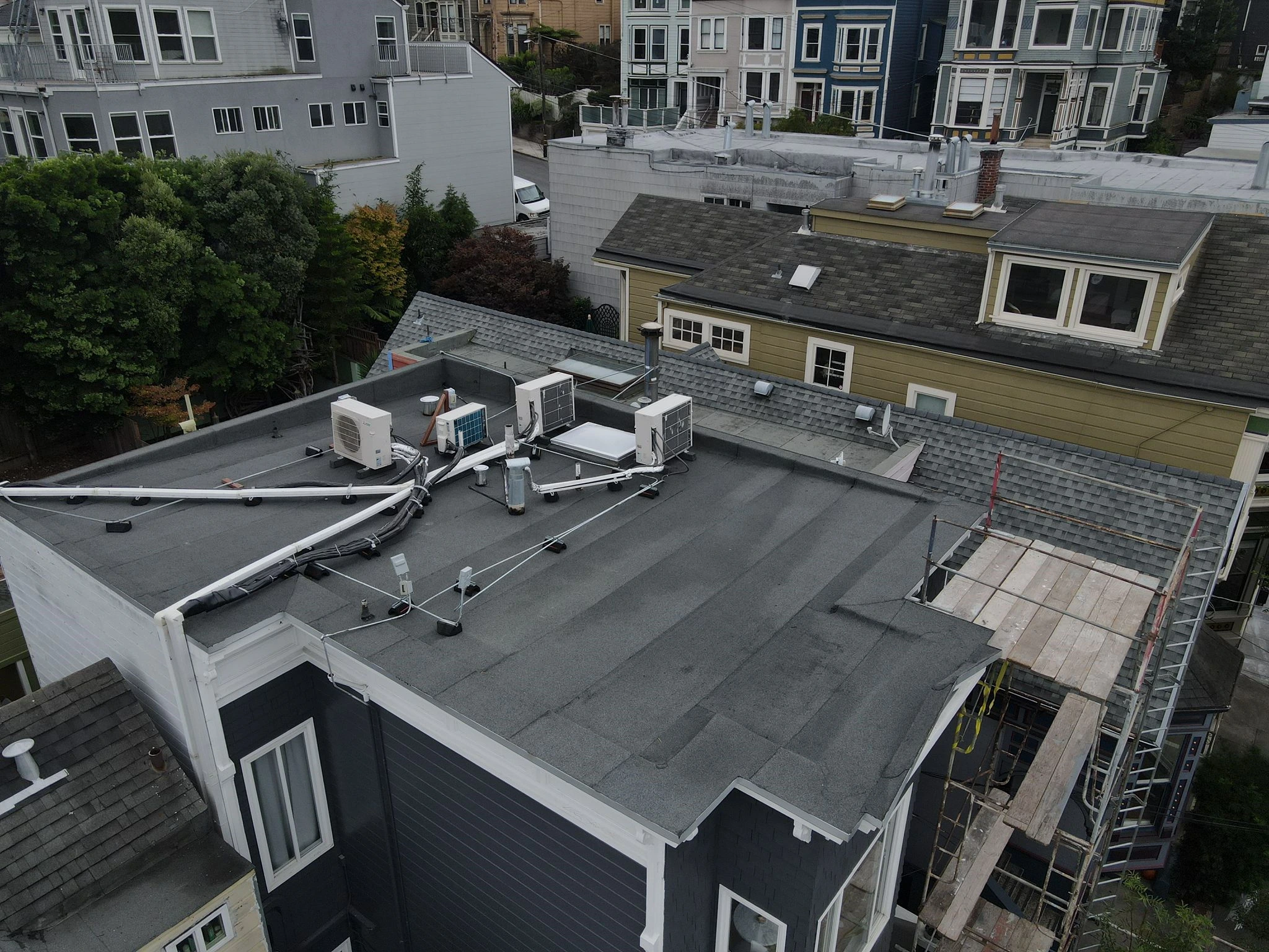 black flat commercial roof with AC